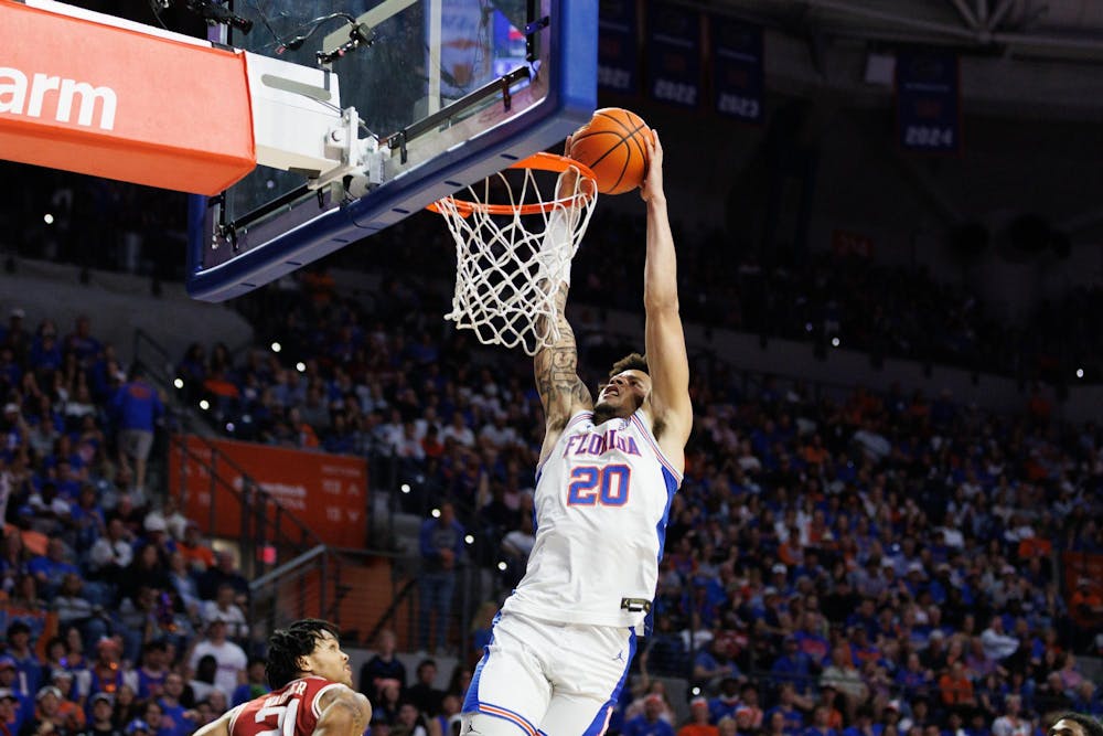 Florida guard Isaiah Brown (20) dunks the ball during the first half of an NCAA basketball game against Arkansas, Saturday, Feb.28, 2026, in Gainesville, Fla.
