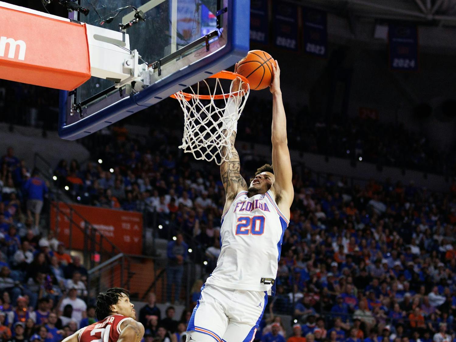 Florida guard Isaiah Brown (20) dunks the ball during the first half of an NCAA basketball game against Arkansas, Saturday, Feb.28, 2026, in Gainesville, Fla.