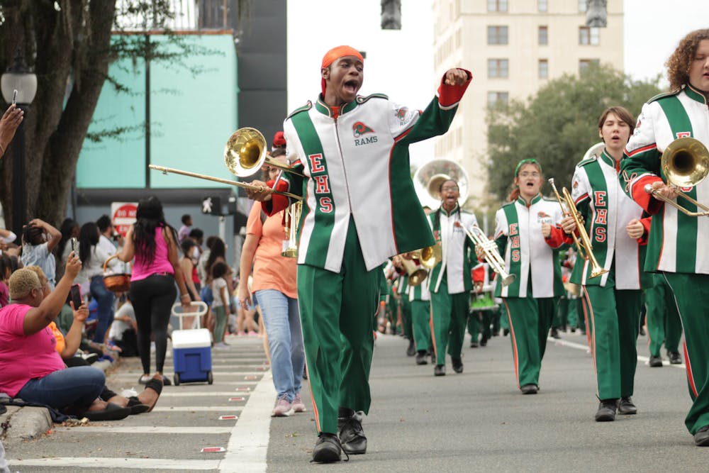  An Eastside High School marching band member chants along with other performers at the City of Gainesville Holiday Parade on Saturday, Dec. 2, 2023
