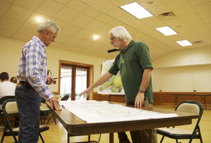 Andrew Kaplan shows a potential buyer an architectural rendering of the upcoming cohousing community, which will be located at 4500 NW 27th Ave.&nbsp;
