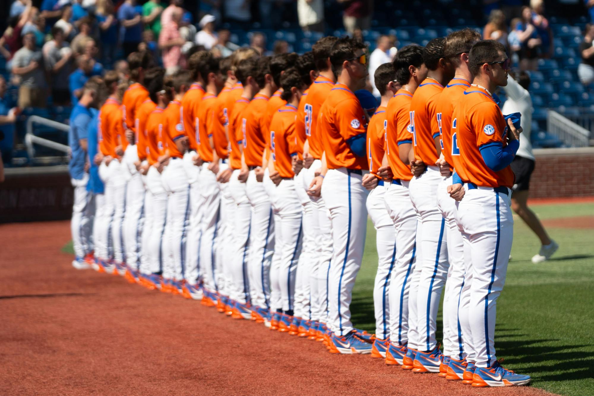 The UF baseball team stands at attention for the playing of the National Anthem at Condron Family Ballpark in March 2024. 
