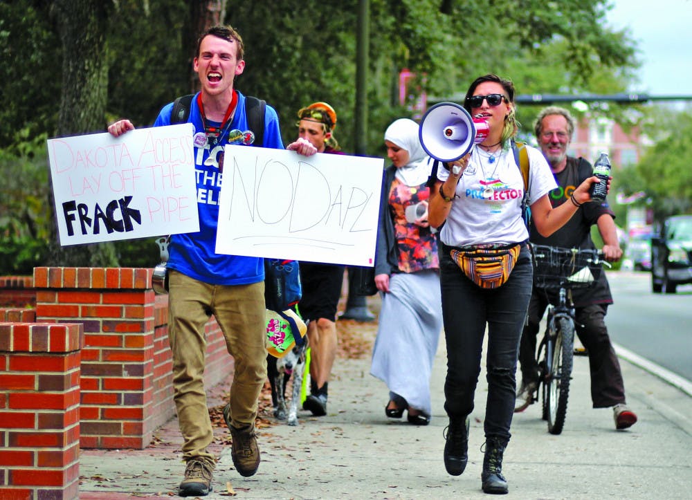 Abee, a 20-year-old who declined to give her last name, and Joseph Ryan, 24, lead a small group of protesters on University Avenue while chanting, "You can't drink oil, keep it in the soil." The group met up with another group of protestors at the Wells Fargo &amp; Co. bank, located at 104 N. Main St., in an attempt to ask them to divest from energy transfer partners. The group also aimed to stand in solidarity with the Dakota Standing Rock Sioux tribe. 