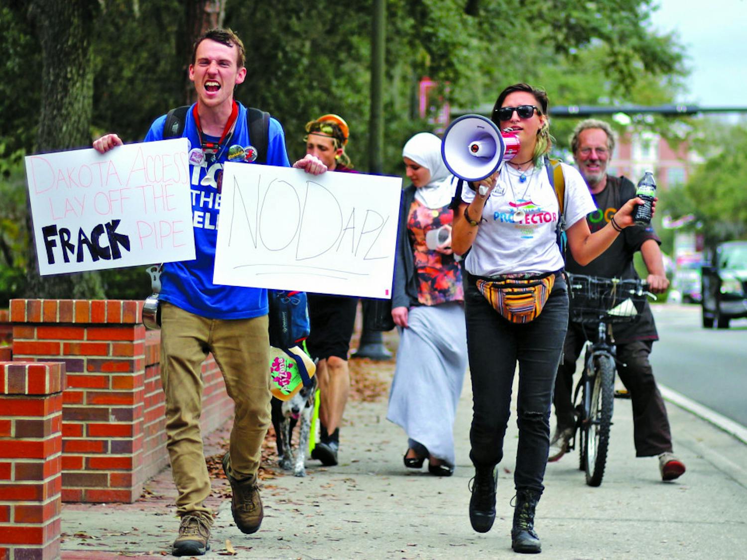 Abee, a 20-year-old who declined to give her last name, and Joseph Ryan, 24, lead a small group of protesters on University Avenue while chanting, "You can't drink oil, keep it in the soil." The group met up with another group of protestors at the Wells Fargo & Co. bank, located at 104 N. Main St., in an attempt to ask them to divest from energy transfer partners. The group also aimed to stand in solidarity with the Dakota Standing Rock Sioux tribe.