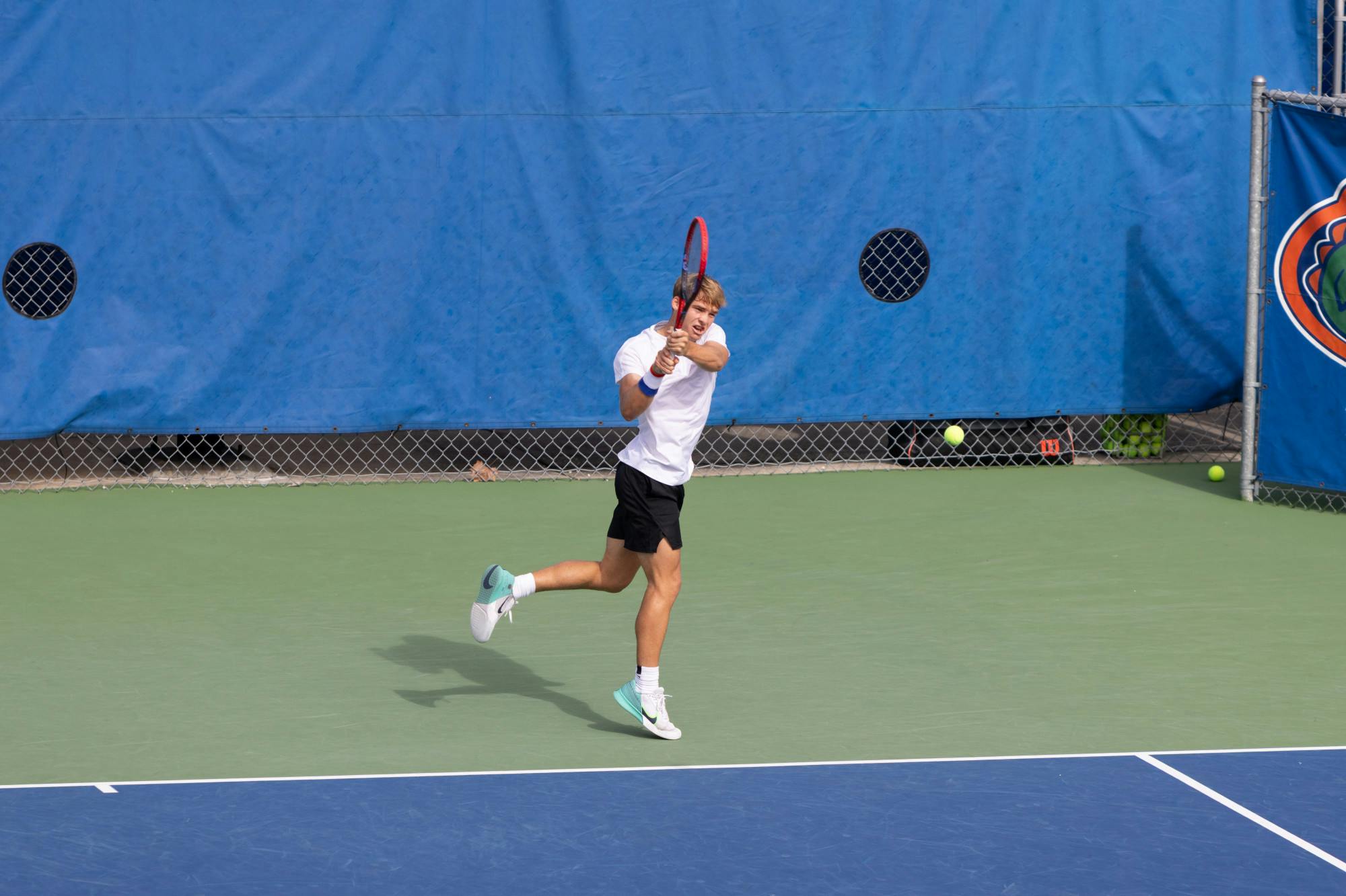 Gators men's tennis freshman Kevin Edengren hits a backhand shot in the team's match against The Citadel on Friday, January 19, 2024. 