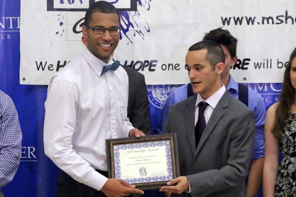 Michael Brown (left), a 22-year-old UF nutritional science senior who has multiple sclerosis, receives a certificate for a $1,500 scholarship from David Nassau, the 20-year-old co-founder of Hopping 4 A Cure, a non-profit dedicated to raising money for MS research. Gainesville residents eligible for the scholarship must be affected by or diagnosed with MS.