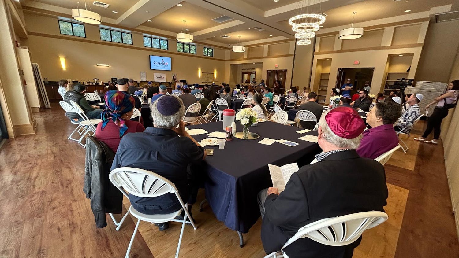 Members of the local Jewish community listen to Chabad UF co-director Chanie Goldman speak on the importance of prayer at the Chabad UF Jewish Student Center on Sunday, Oct. 22, 2023. 