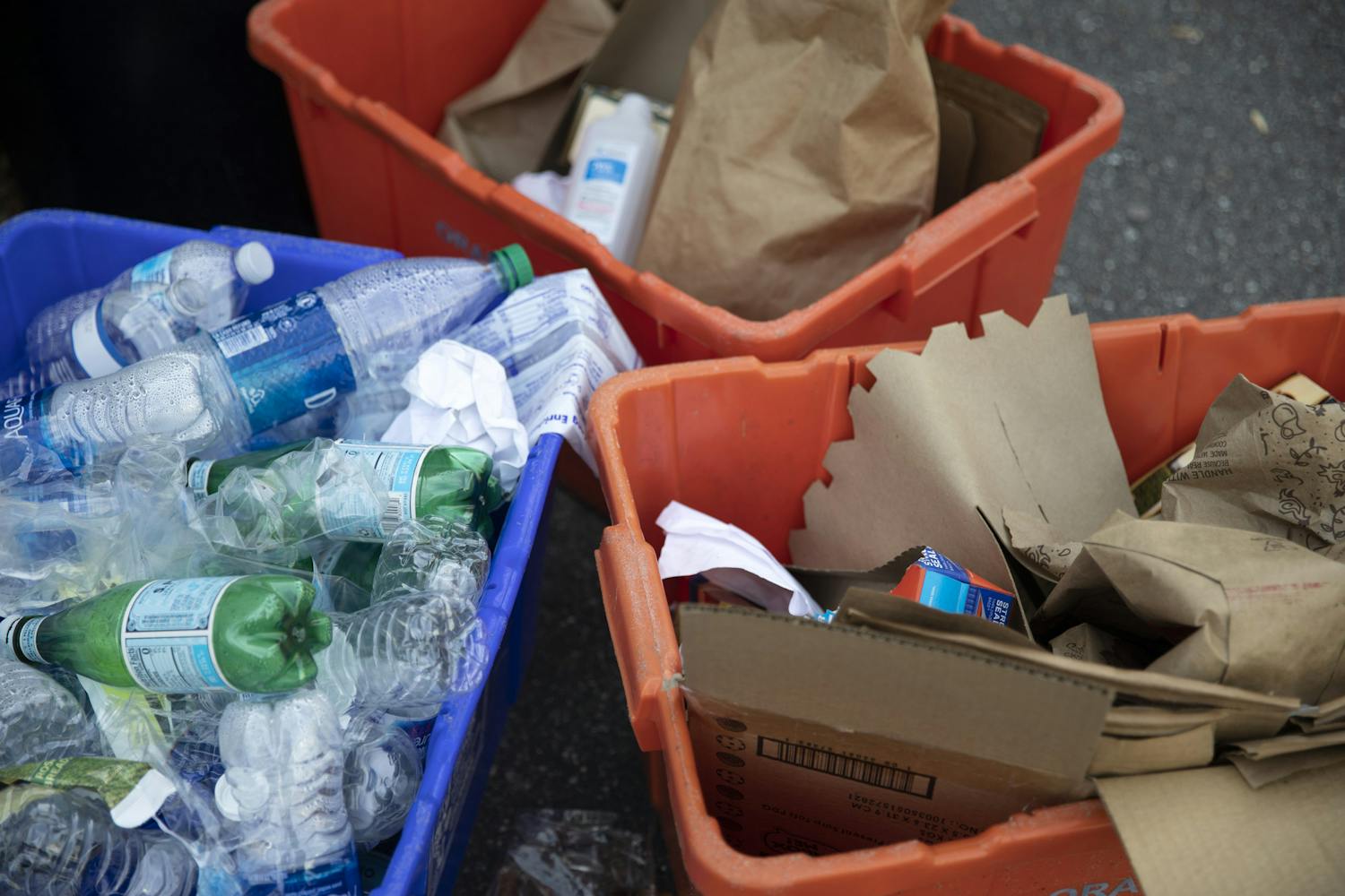 Plastic bottles and cartons were placed inside of orange and blue bins for recycling on Southwest 23rd Drive in Gainesville on Wednesday, May 12, 2021. 