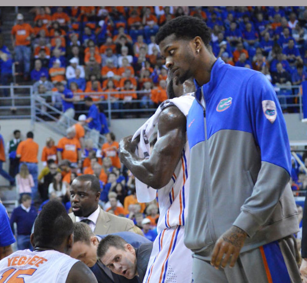 <p>Chris Walker stands on the sideline as the Gators warm up during Florida’s win against Tennessee on Saturday in the O’Connell Center.</p>