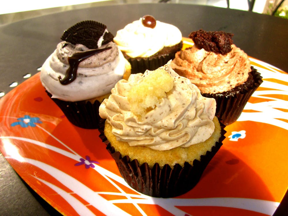 <p><span>Four cupcakes (clockwise from back): Espresso, Chocolate Explosion, Caramel Latte and Oreo</span></p>