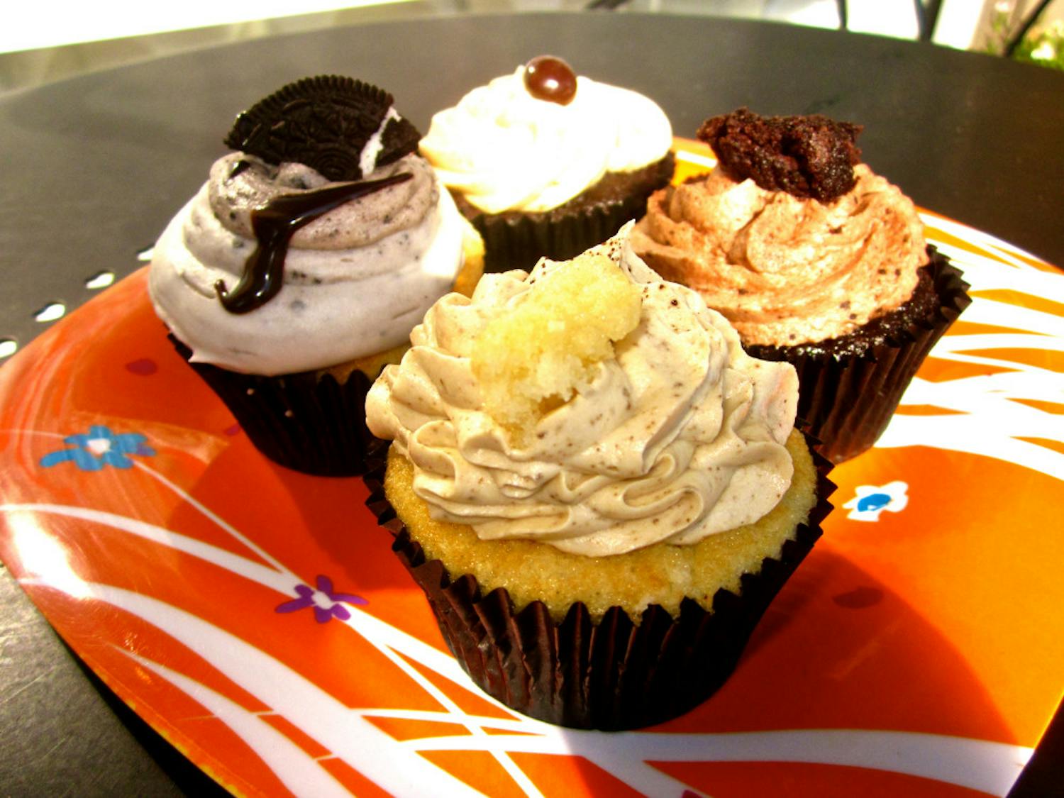 Four cupcakes (clockwise from back): Espresso, Chocolate Explosion, Caramel Latte and Oreo