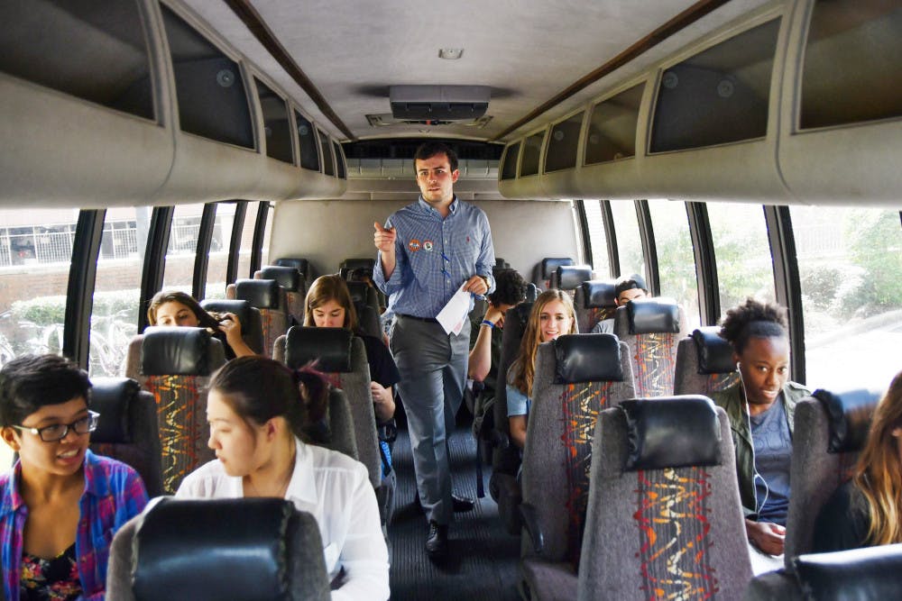 Ryan Mockabee, a 21-year-old UF behavioral and cognitive neuroscience senior, counts off people on an early-voting shuttle on Tuesday. With an hour and a half left to run, the shuttles, offered by the Bob Graham Center for Public Service, had already taken 91 people. 