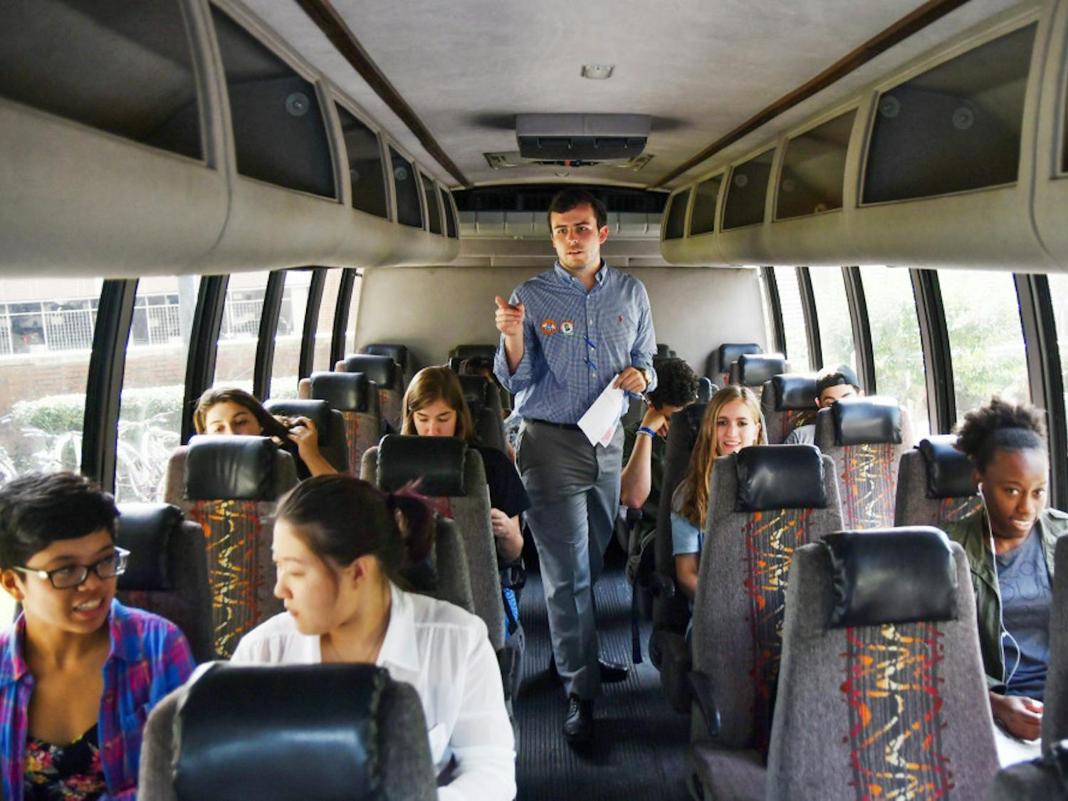 Ryan Mockabee, a 21-year-old UF behavioral and cognitive neuroscience senior, counts off people on an early-voting shuttle on Tuesday. With an hour and a half left to run, the shuttles, offered by the Bob Graham Center for Public Service, had already taken 91 people.