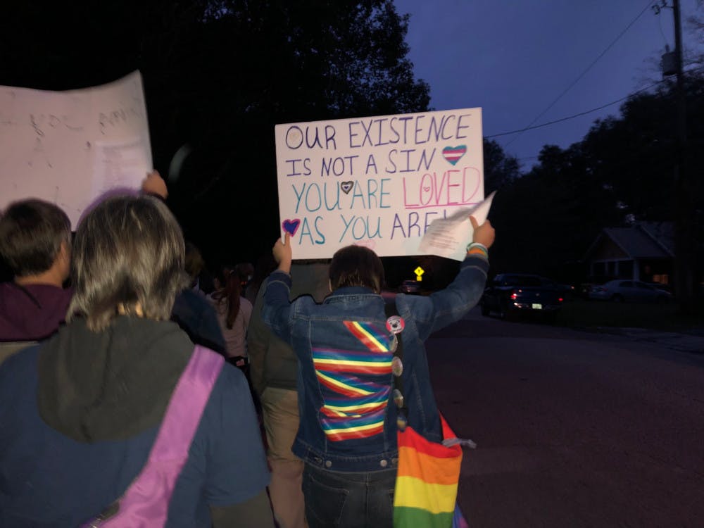 <p><span id="docs-internal-guid-dcd4d5d1-7fff-9f42-2ccc-6afae9238980"><span>Gainesville Free2BU protesters carry hand-made signs Friday evening as they march towards the Ignite Life Center, whose members they say use conversion therapy on the LGBTQ+ community</span></span></p>