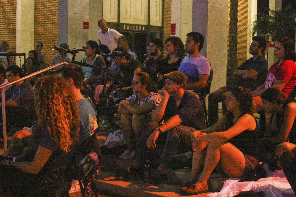 Students attend a film screening of “2 or 3 Things I Know About Her” at the Fine Arts plaza Sept. 22, 2015. Steve Hersh (back row, second from right), a 29-year-­old Library West employee, said he attended the Films under the Stars event a few weeks ago and had a great time he returned. “It’s just really nice to see a movie outdoors,” he said. The films are shown Tuesday nights from 8­ p.m. to 10 p.m.
