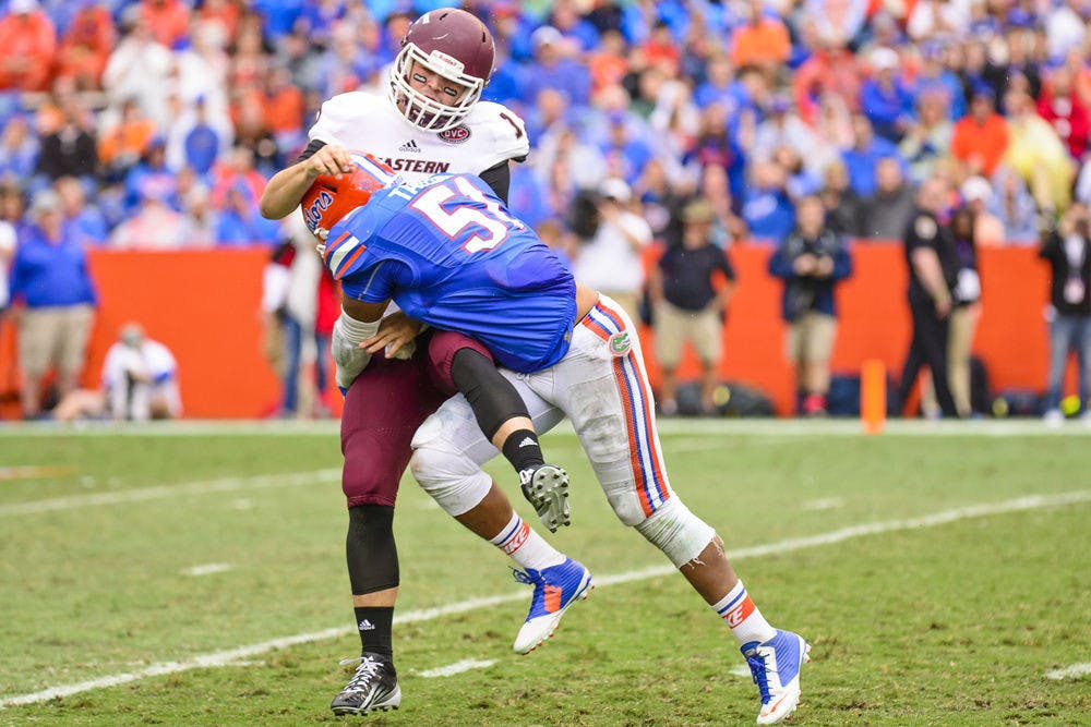 <p>Mike Taylor makes a tackle during Florida's win against Eastern Kentucky on Saturday at Ben Hill Griffin Stadium.</p>