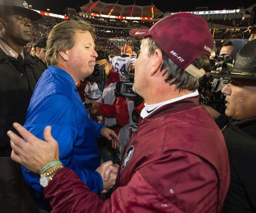 Florida coach Jim McElwain, left, and&nbsp;FSU coach Jimbo Fisher meet at mid-field after the Seminoles&nbsp;defeated the Gators&nbsp;31-13 in an NCAA college&nbsp;football&nbsp;game in Tallahassee, Fla., Saturday, Nov. 26, 2016. (AP Photo/Mark Wallheiser)