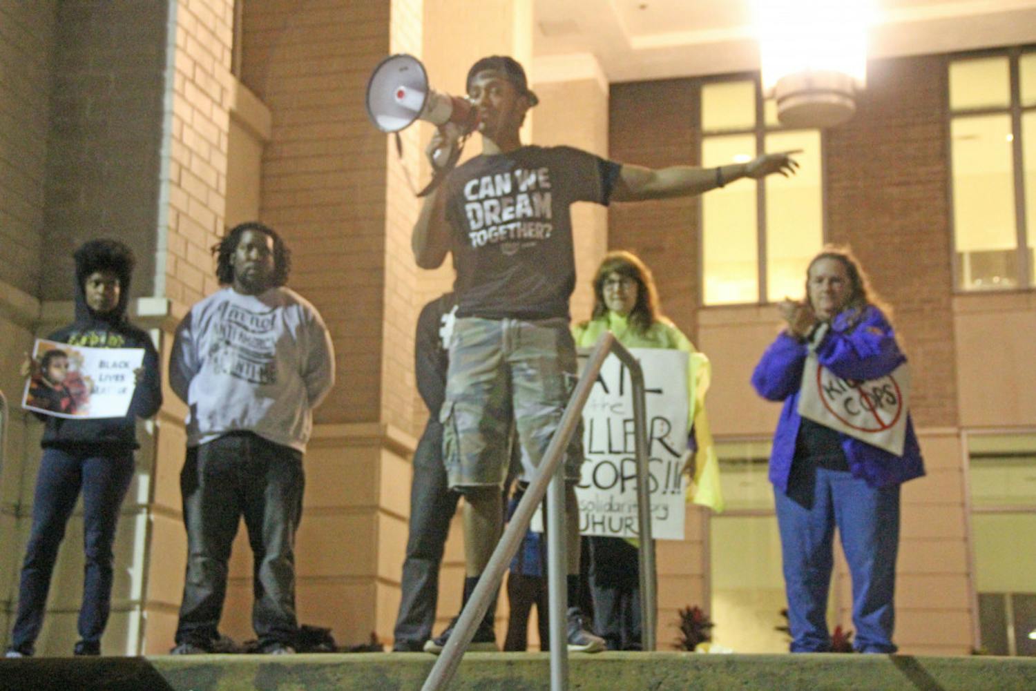 Azaari Mason, a 19-year-old UF political science junior, speaks to a crowd of people at the Gainesville Courthouse downtown Tuesday evening. 