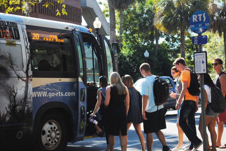 Students wait in line to board a bus Wednesday afternoon. Gainesville RTS set new ridership records for this fiscal year, which ran through Sept. 30.
