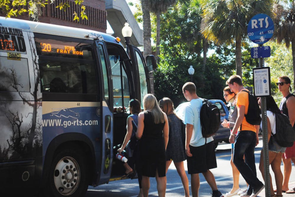 <p>Students wait in line to board a bus Wednesday afternoon. Gainesville RTS set new ridership records for this fiscal year, which ran through Sept. 30.</p>