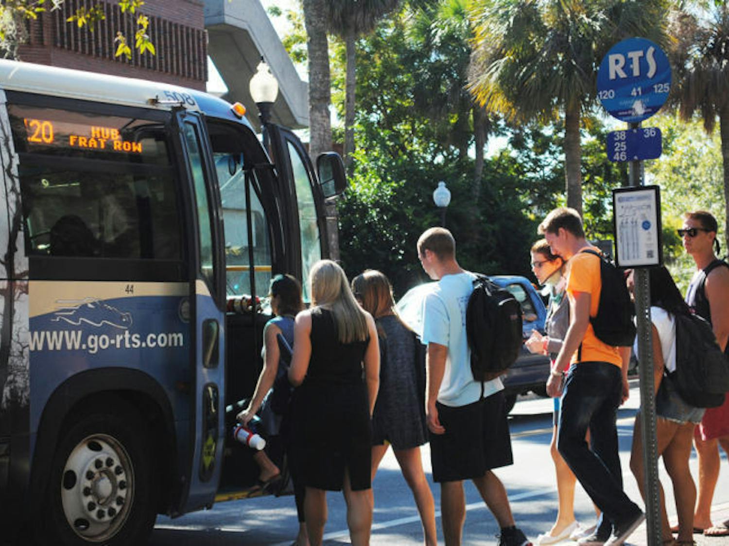 Students wait in line to board a bus Wednesday afternoon. Gainesville RTS set new ridership records for this fiscal year, which ran through Sept. 30.