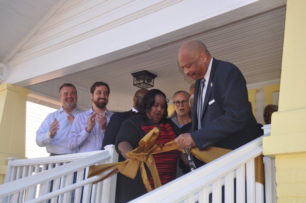 City employees cut the ribbon in front of the new A. Quinn Jones Museum and Cultural Center. The museum, which was A. Quinn Jones’ former home, is set to open in April.