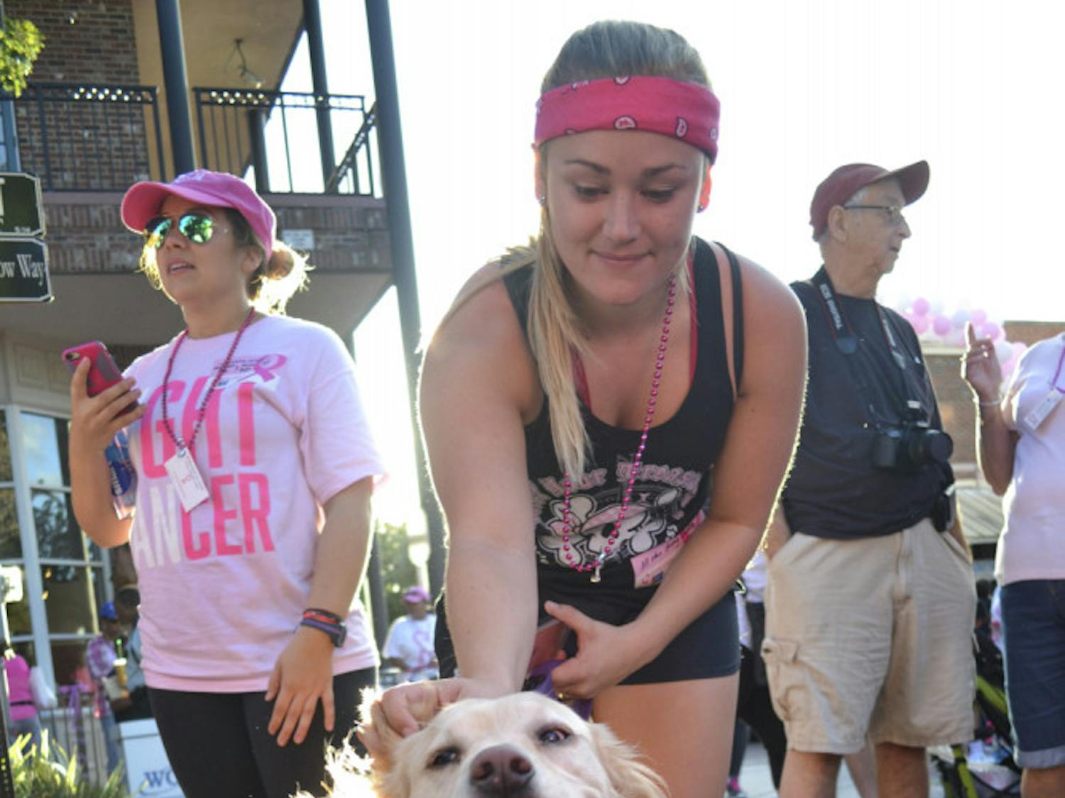 Honey, a 6-year-old golden retriever lab mix, wags her tail as owner Kendall Nettles gets ready to walk the Making Strides Against Breast Cancer 5k on Oct. 24, 2015. The 22-year-old Santa Fe early childhood education senior said it was important to support those with breast cancer and those who had lost their lives.