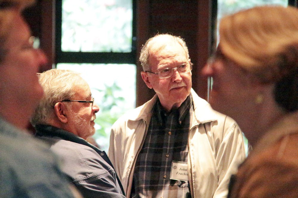 Luis Pedreira, left, and his partner John Franchiseur, listen to Associate Minister Andrew M. Bachmann during a marriage blessing at United Church of Gainesville on Sunday morning. Pedreira and Franchiseur have been together for 47 years and were one of 13 couples blessed.