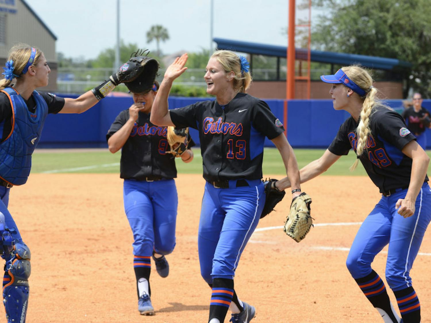Junior pitcher Hannah Rogers (13) celebrates with her teammates following Florida’s 2-0 win against South Florida on Sunday afternoon at Katie Seashole Pressly Stadium.