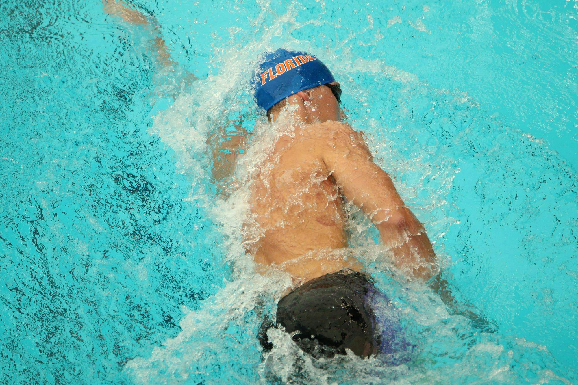 A Gators swimmer traverses through the water at Florida's home opening meet against Virginia on Friday, Oct. 11, at the Stephen C. O'Connell Center Natatorium, in Gainesville, Florida.