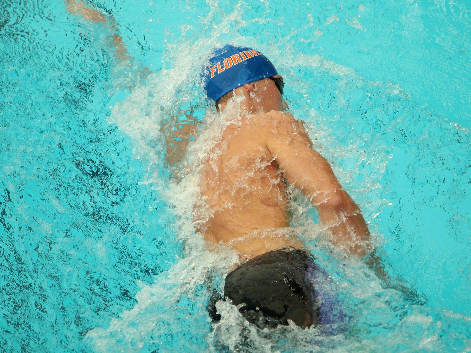 A Gators swimmer traverses through the water at Florida's home opening meet against Virginia on Friday, Oct. 11, at the Stephen C. O'Connell Center Natatorium, in Gainesville, Florida.