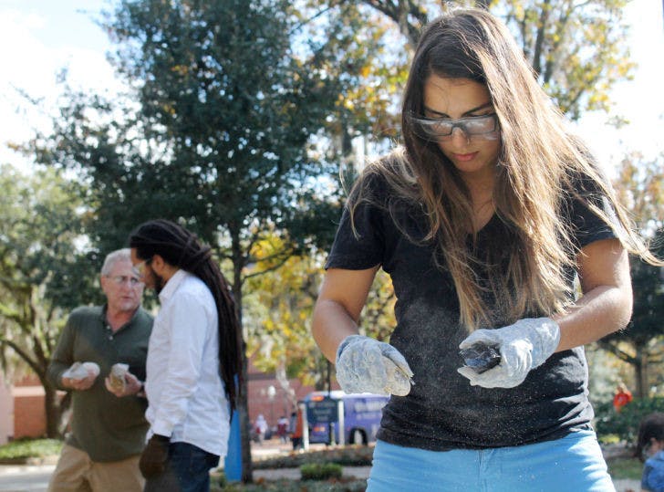 Michelle Gray, a 21-year-old UF anthropology major, practices flintknapping exercises in preparation for a study abroad trip to the Mochena Borago Rockshelter in Ethiopia this February.
