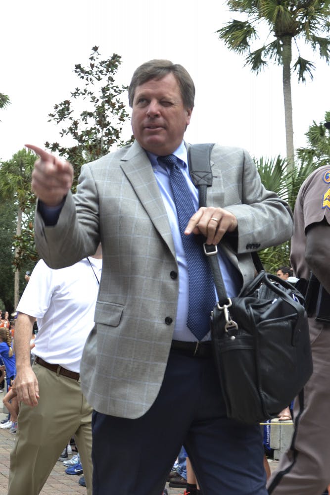 UF coach Jim McElwain points to the crowd during Gator Walk prior to Florida's 20-14 overtime win against Florida Atlantic on Nov. 21, 2015.