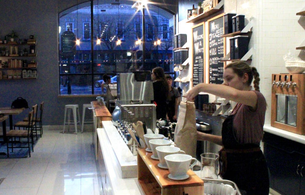 Emily Hart, a 20-year-old UF psychology student, scoops fresh coffee grounds from a bag on Sunday afternoon at Wyatt’s Coffee’s new downtown location at 202 SE Second Ave. 