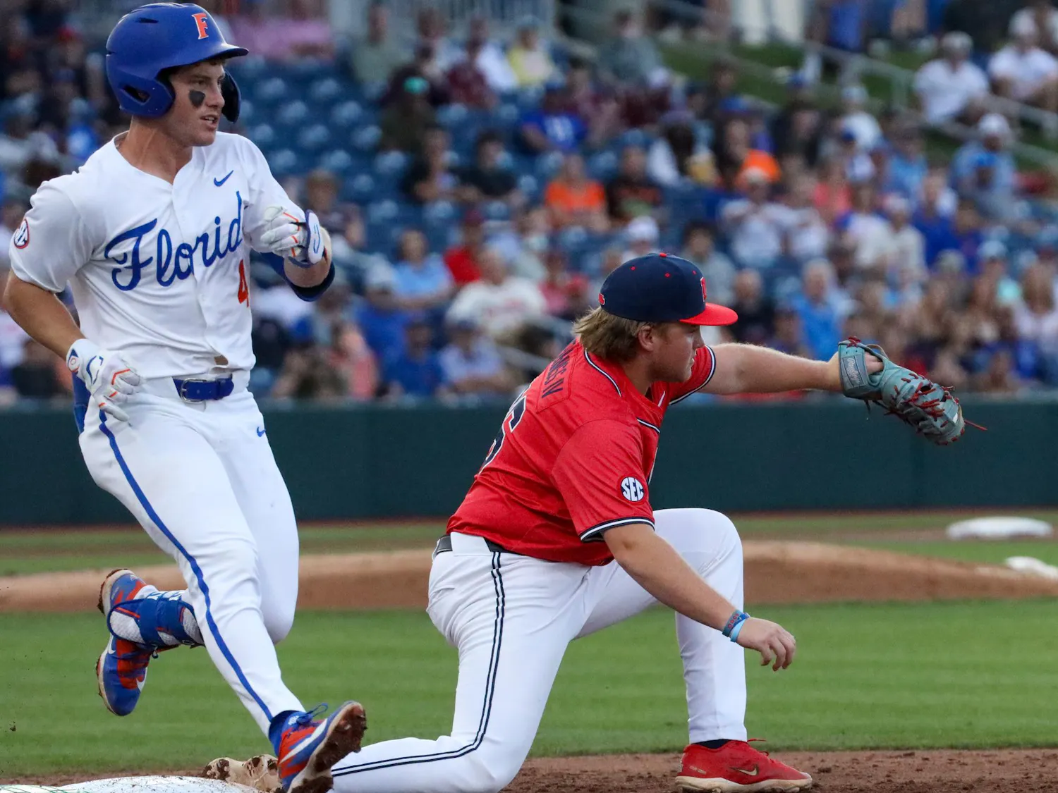 Ole Miss infielder Will Furniss (36) gets out Cade Kurland (4) at first base during an NCAA college baseball game against Florida, Thursday, April 2, 2026, in Gainesville, Fla.