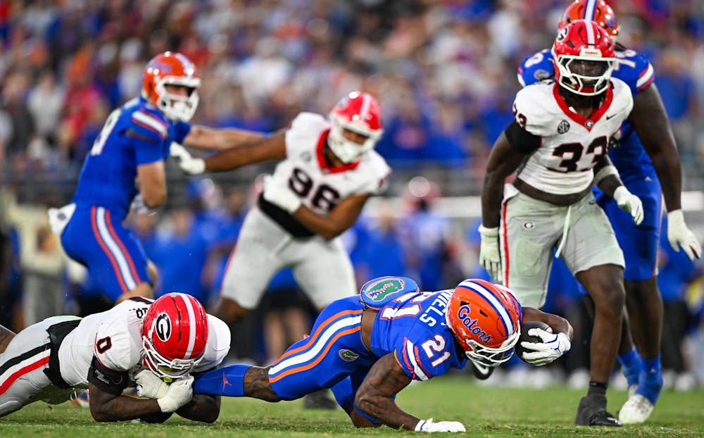 Florida running back KD Daniels (21) reaches with the ball during a NCAA college football game, Saturday, Nov. 1, 2025, in Jacksonville, Fla.