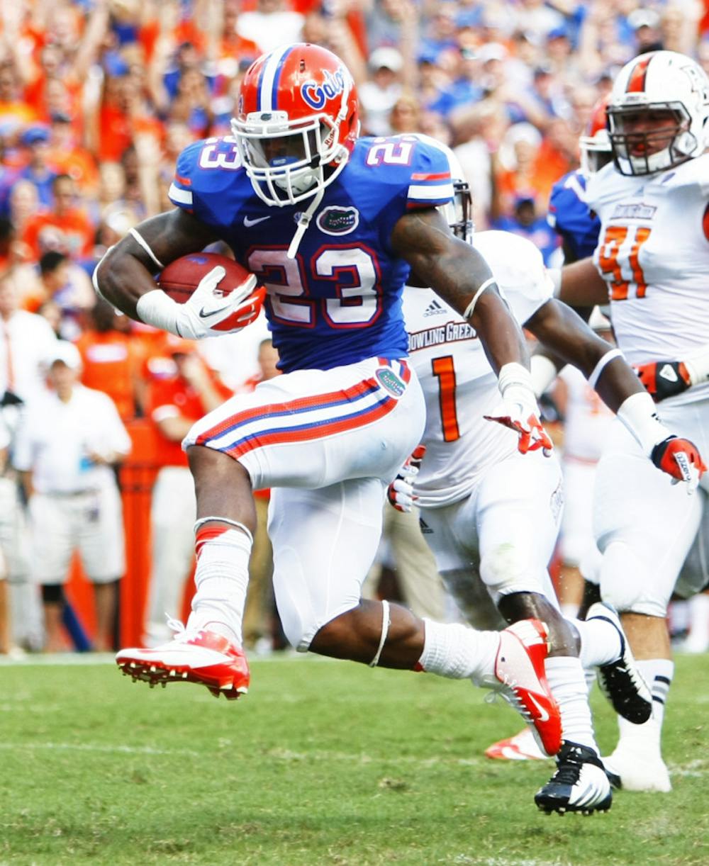 <p>Mike Gillislee runs in a touchdown Saturday against Bowling Green University at Ben Hill Griffin Stadium.</p>