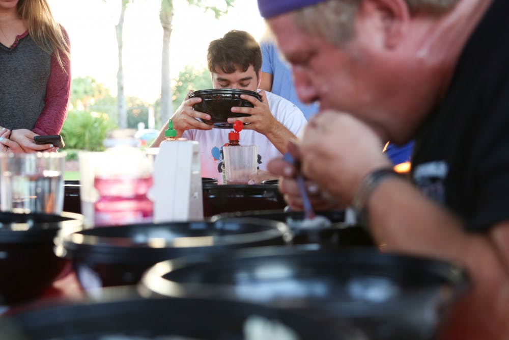 Robert Lug, a 20-year-old UF mechanical engineering junior, participates at the Pho-eating contest at Taste Pho and Noodle House on Thursday evening.