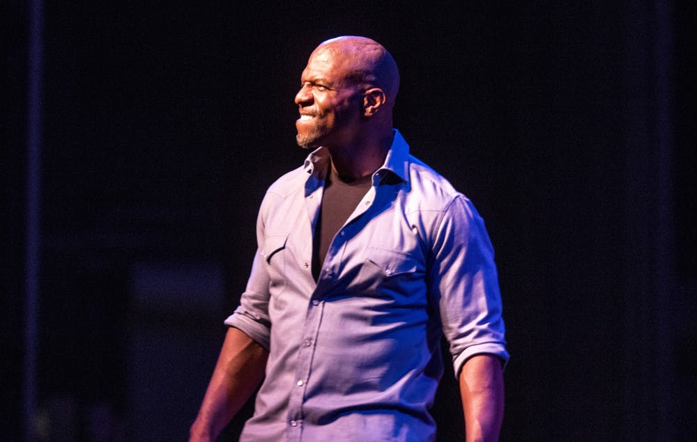Terry Crews smiles for the crowd as he makes an enthusiastic entrance inside the Phillips Center for the Performing Arts on Tuesday night at the Accent Speakers Bureau-hosted event. Crews shared stories of rejection and perseverance along his journey of success.
