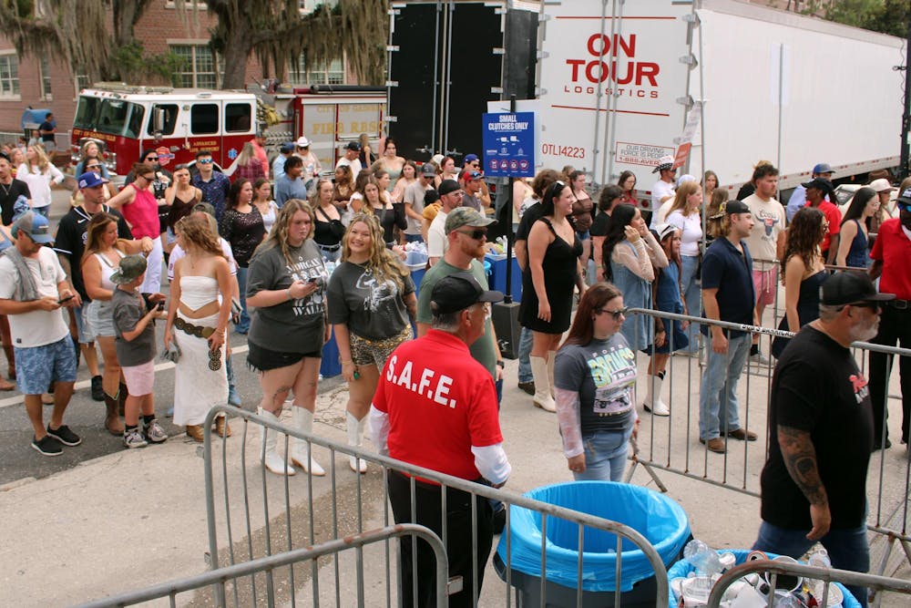 A crowd walks towards security check in for the Morgan Wallen Concert in front of the Ben Hill Griffin Stadium in Gainesville, Fla. on Saturday, May 16, 2026