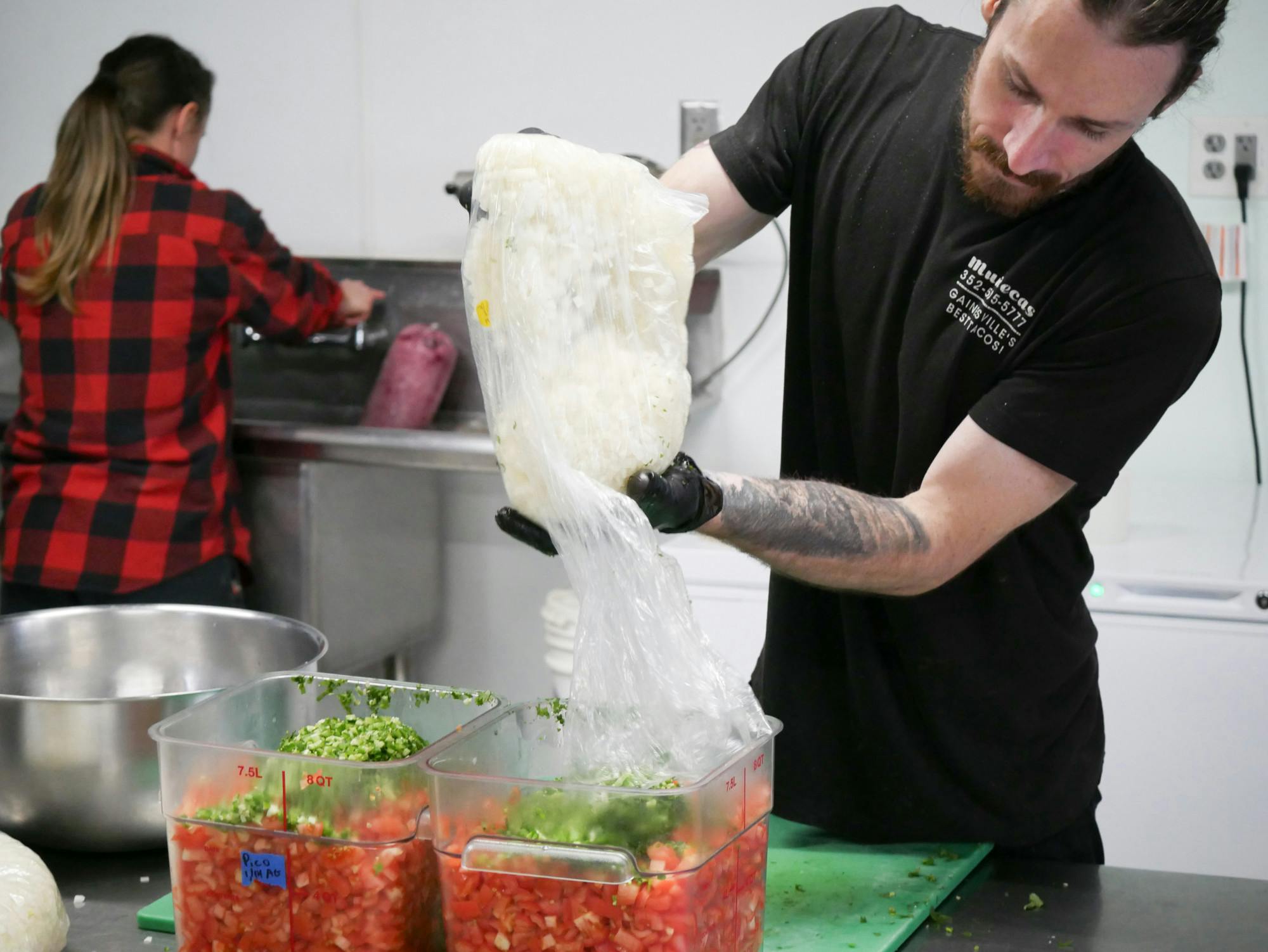An employee prepares food at Muñecas Taco Garden and Bar on Sunday, Jan. 14, 2024.