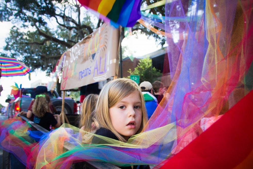 Seven-year-old Elizabeth Poe, daughter of Gainesville Mayor Lauren Poe, sits on a parade float Saturday afternoon during the the Gainesville Pride Parade. “Pride gets bigger and better and more celebratory every year,” Mayor Poe said. 