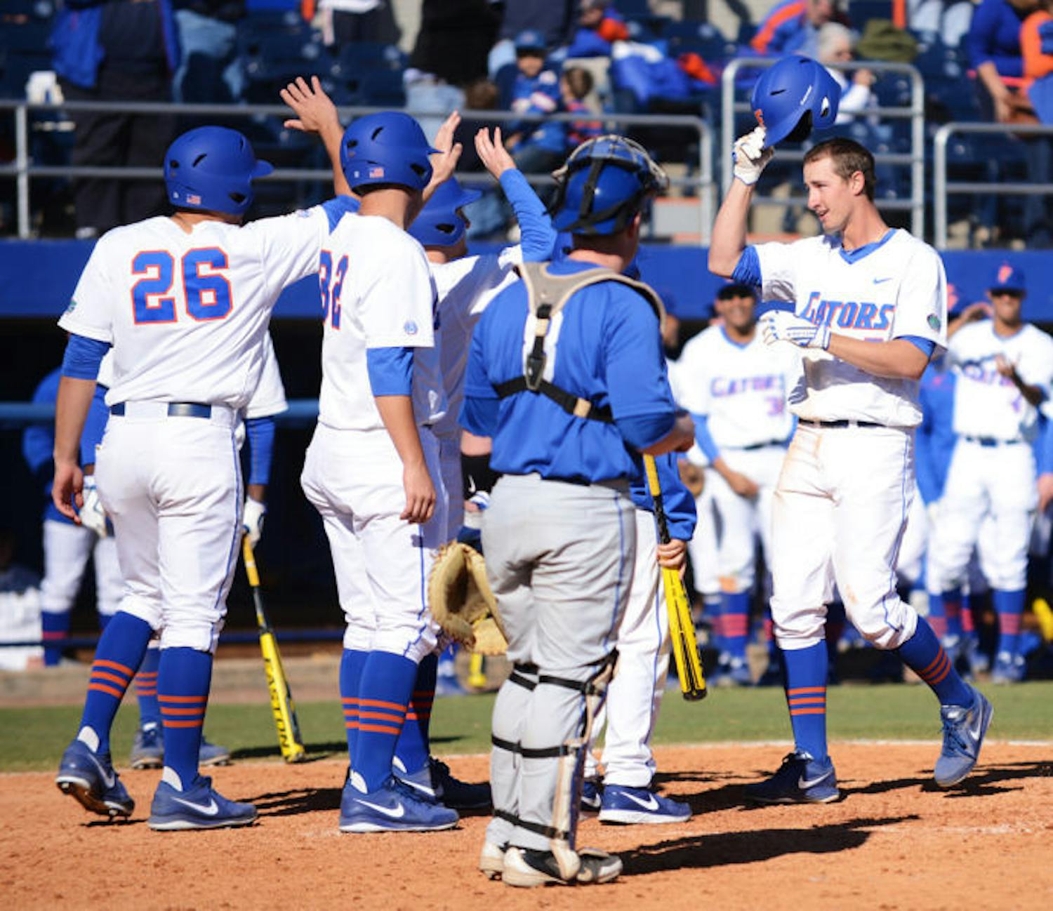 Sophomore Zack Powers is congratulated by teammates at home plate after hitting his second grand slam during Florida’s 16-5 win against Duke on Feb. 17 at McKethan Stadium.
&nbsp;