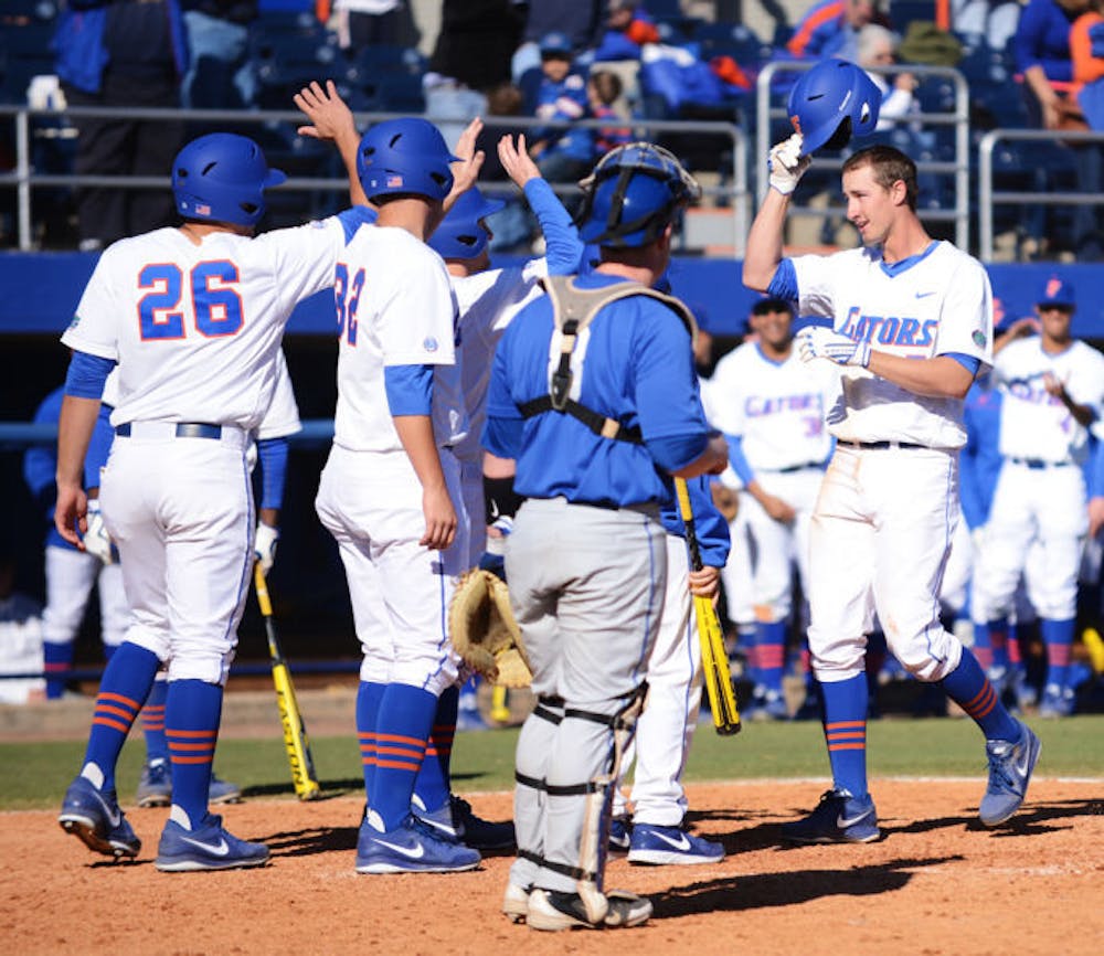 <p>Sophomore Zack Powers is congratulated by teammates at home plate after hitting his second grand slam during Florida’s 16-5 win against Duke on Feb. 17 at McKethan Stadium.</p>
<div>&nbsp;</div>