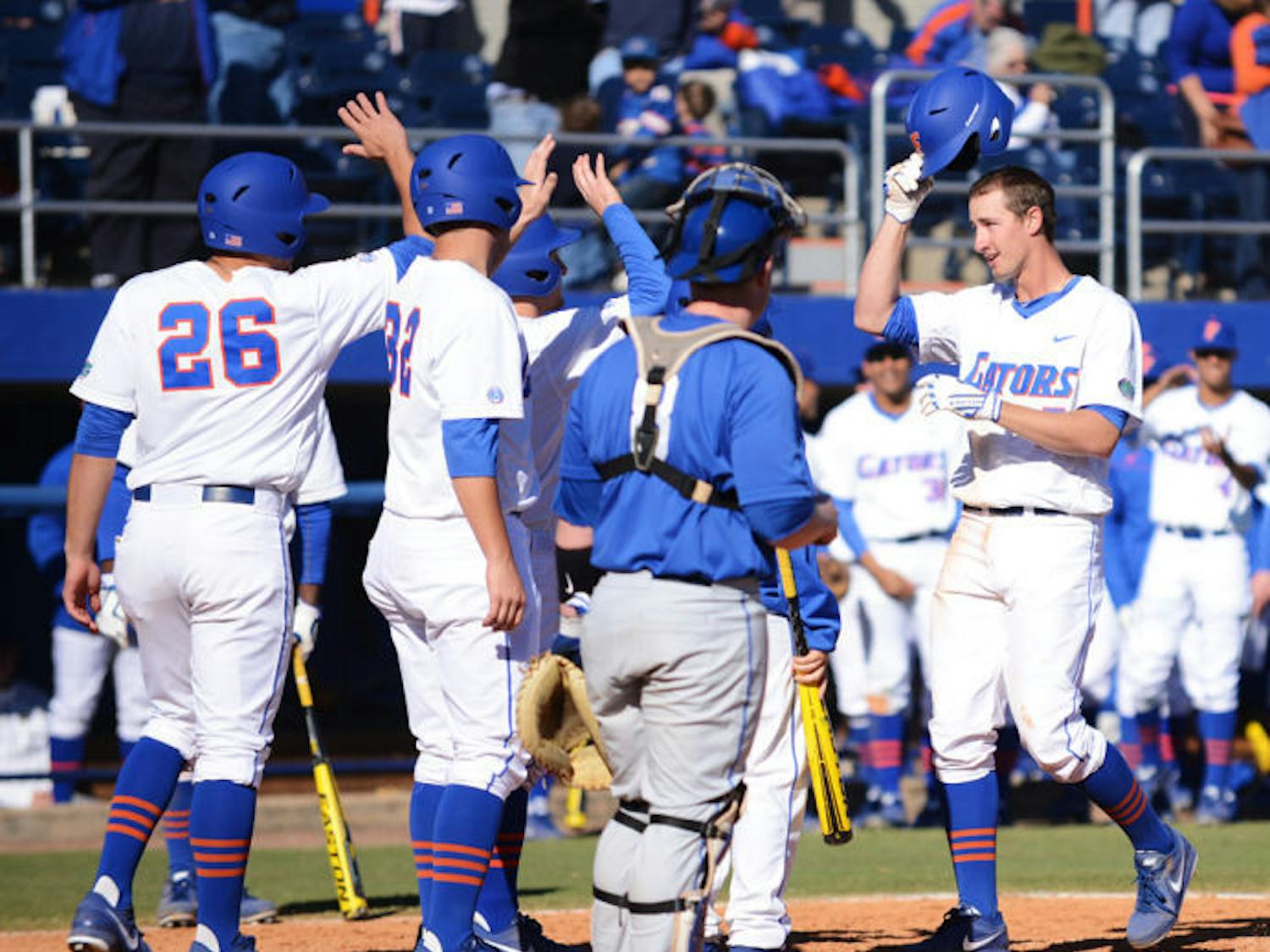 Sophomore Zack Powers is congratulated by teammates at home plate after hitting his second grand slam during Florida’s 16-5 win against Duke on Feb. 17 at McKethan Stadium.
&nbsp;