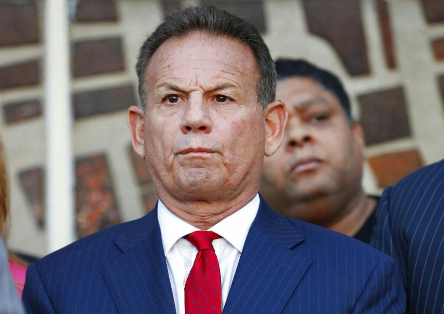In this Jan. 11, 2019, photo, suspended Broward County Sheriff Scott Israel listens to comments by his attorney at a news conference after new Florida Gov. Ron DeSantis suspended Israel in Fort Lauderdale, Fla., over his handling of February's massacre at Marjory Stoneman Douglas High School. Israel testified for seven hours Wednesday, June 19, while fighting to regain his job. A lawyer for DeSantis focused his questions on training that former Deputy Scot Peterson received before the shooting in February 2018. Israel replied that Peterson was trained but there's no way he could have given him the courage to confront the shooter.