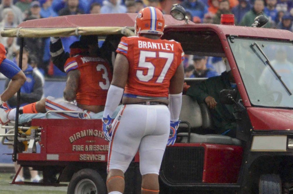 <p>Caleb Brantley watches as linebacker Antonio Morrison is carted off the field during Florida's 28-20 win in the Birmingham Bowl on Saturday, Jan. 3, 2015, at Legion Field.</p>