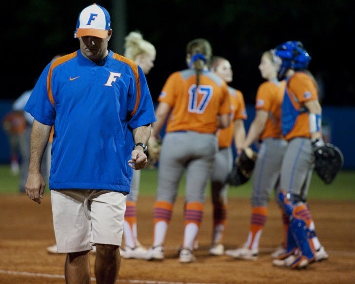 Florida coach Tim Walton walks back to the dugout after a team meeting during the Gators’ 4-1 loss to USF on Wednesday night. Freshman Lauren Haeger picked up the loss, allowing two earned runs.