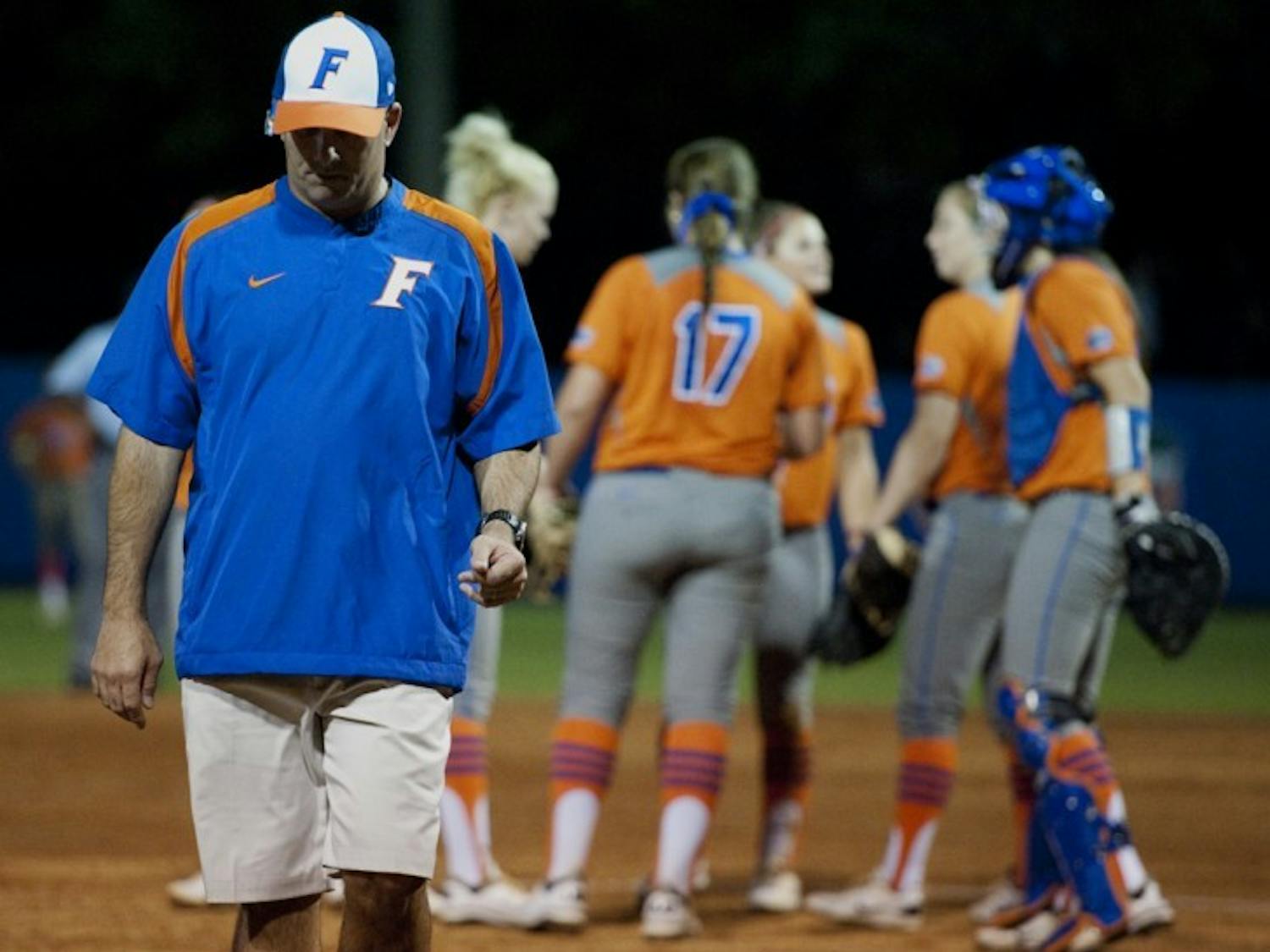 Florida coach Tim Walton walks back to the dugout after a team meeting during the Gators’ 4-1 loss to USF on Wednesday night. Freshman Lauren Haeger picked up the loss, allowing two earned runs.