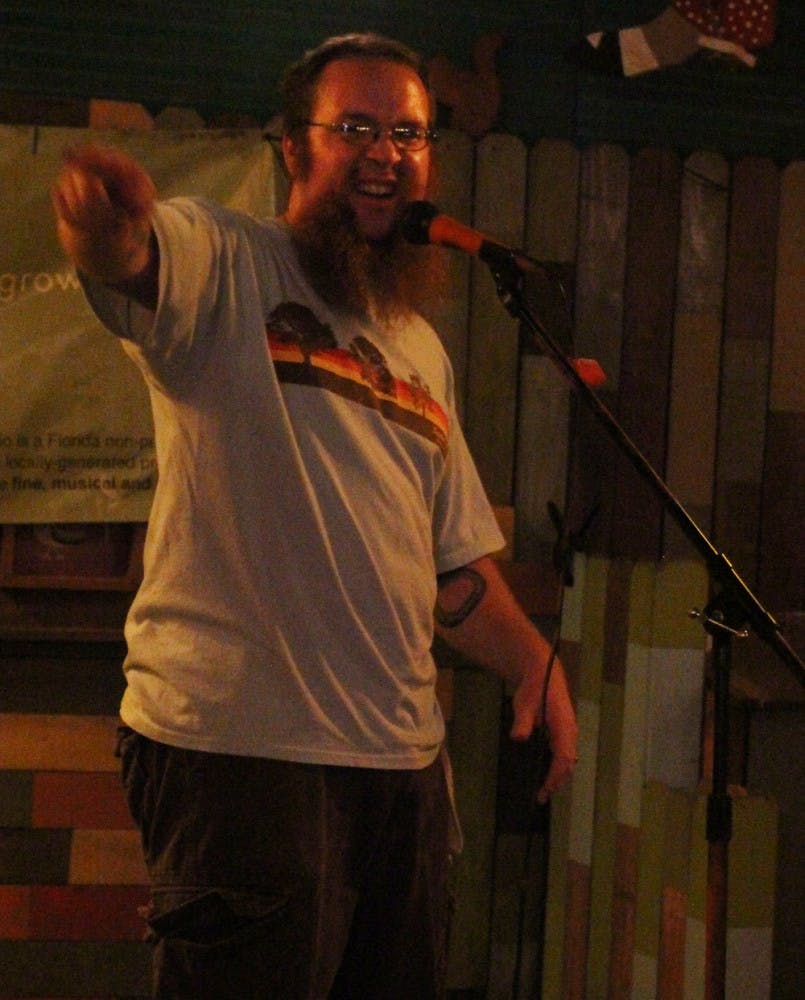 Satchel's Pizza bartender Jordan Borstelmann, 31, tells an anecdote at Grow Radio's storytelling event, The Conch. The event was at Satchel's Pizza, and performing members had five minutes to tell stories.