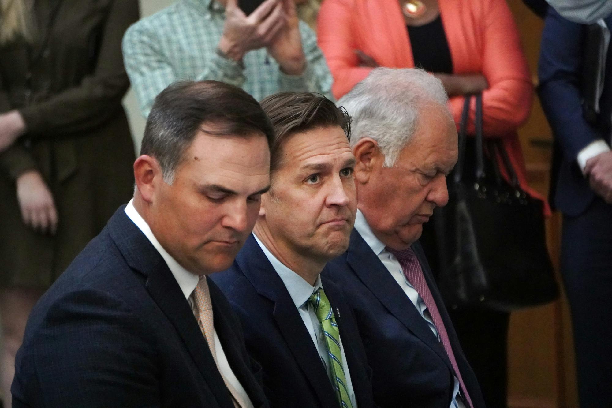 New UF president Ben Sasse sits between Patrick Zalupski (left) and Mori Hosseini (right) during a press conference at Jacksonville City Hall Tuesday, Feb. 7, 2023.